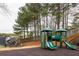 Community playground area surrounded by mature trees, providing shade and a natural setting at 5877 Stow Dr, Tucker, GA 30084