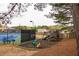 Community playground with swings, play structure, and tennis court at 5877 Stow Dr, Tucker, GA 30084