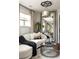 Elegant sitting area featuring curved sofa, designer mirror, and stylish decor at 5877 Stow Dr, Tucker, GA 30084