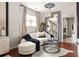 Charming sitting area with a curved sofa, accent pillows, floor-to-ceiling mirror, and designer touches at 5877 Stow Dr, Tucker, GA 30084