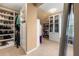 Spacious walk-in closet with custom shelving and storage for clothes, shoes and handbags at 5877 Stow Dr, Tucker, GA 30084