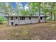 Back exterior view of a light-colored home with a sloped yard at 8065 Highway 92 Dallas, Douglasville, GA 30134