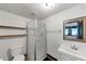Functional bathroom with a stand-up shower, floating shelves, white vanity, and a new toilet at 8065 Highway 92 Dallas, Douglasville, GA 30134