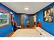 A bedroom featuring blue walls, hardwood floors, and a chair at 8065 Highway 92 Dallas, Douglasville, GA 30134