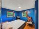 Bright bedroom with blue walls, wood floors, and good lighting at 8065 Highway 92 Dallas, Douglasville, GA 30134