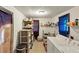 Bright laundry room with washer, dryer, shelving, and tile floor at 8065 Highway 92 Dallas, Douglasville, GA 30134