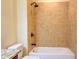 This warm bathroom features a tiled shower and bathtub combo with bronze hardware at 120 Chastain Nw Rd # 1104, Kennesaw, GA 30144