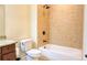 This bathroom features a tiled shower and bathtub combo with granite countertop and bronze hardware at 120 Chastain Nw Rd # 1104, Kennesaw, GA 30144