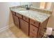 Bathroom vanity with granite counters and warm wood cabinets at 120 Chastain Nw Rd # 1104, Kennesaw, GA 30144