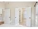 Bedroom with bright windows, bi-fold bathroom doors, and ceiling fan at 120 Chastain Nw Rd # 1104, Kennesaw, GA 30144