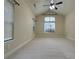 Large bedroom with vaulted ceiling, carpet flooring, and many windows at 120 Chastain Nw Rd # 1104, Kennesaw, GA 30144