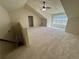 Large bonus room featuring neutral carpeting, a ceiling fan, and natural light at 120 Chastain Nw Rd # 1104, Kennesaw, GA 30144