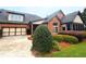 Charming brick home featuring manicured landscaping, a two-car garage, and an inviting sunroom at 120 Chastain Nw Rd # 1104, Kennesaw, GA 30144