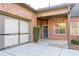 Welcoming entrance features a brick facade, attached garage, and charming front door decor at 120 Chastain Nw Rd # 1104, Kennesaw, GA 30144