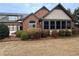 Charming home featuring a brick facade, manicured landscaping, and a cozy screened porch area at 120 Chastain Nw Rd # 1104, Kennesaw, GA 30144