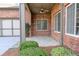 Covered front porch offers a welcoming entrance with neat landscaping and a fan overhead at 120 Chastain Nw Rd # 1104, Kennesaw, GA 30144