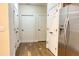 Hallway with LVP floors featuring stainless steel refrigerator and multiple door closets at 120 Chastain Nw Rd # 1104, Kennesaw, GA 30144
