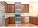 Spacious kitchen features stainless steel appliances, granite countertops, and wooden cabinetry at 120 Chastain Nw Rd # 1104, Kennesaw, GA 30144
