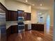 Modern kitchen with stainless appliances, dark wood cabinets, and granite counters, seamlessly blending style and function at 120 Chastain Nw Rd # 1104, Kennesaw, GA 30144