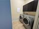 Laundry room features tile flooring and modern washer and dryer at 120 Chastain Nw Rd # 1104, Kennesaw, GA 30144
