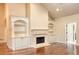 Spacious living room featuring a fireplace, built-in shelving and hardwood floors at 120 Chastain Nw Rd # 1104, Kennesaw, GA 30144