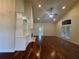 Bright living room featuring hardwood floors, built-in shelving, and a ceiling fan at 120 Chastain Nw Rd # 1104, Kennesaw, GA 30144