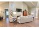 Spacious living room featuring a fireplace, vaulted ceiling, and wood-look tile flooring at 120 Chastain Nw Rd # 1104, Kennesaw, GA 30144