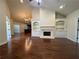 Inviting living area featuring hardwood floors, a fireplace with built-ins, and an open layout at 120 Chastain Nw Rd # 1104, Kennesaw, GA 30144