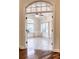 View of a room featuring tile floors and a ceiling fan, as seen through an arched doorway at 120 Chastain Nw Rd # 1104, Kennesaw, GA 30144
