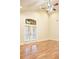 Bright living room with vaulted ceiling, fan, hardwood floors, and large windows and doors at 120 Chastain Nw Rd # 1104, Kennesaw, GA 30144