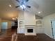 Cozy living room with hardwood floors, a fireplace with built-ins, and a stylish ceiling fan at 120 Chastain Nw Rd # 1104, Kennesaw, GA 30144