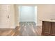 Neutral colored living room featuring hardwood floors and adjacent kitchen space at 120 Chastain Nw Rd # 1104, Kennesaw, GA 30144