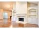 Open-concept living room with fireplace, custom built-ins, and elegant hardwood flooring at 120 Chastain Nw Rd # 1104, Kennesaw, GA 30144
