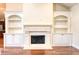 Living room with fireplace and built-ins featuring hardwood floors at 120 Chastain Nw Rd # 1104, Kennesaw, GA 30144