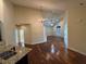Bright living space featuring hardwood floors, elegant chandelier, and view into an open-concept kitchen at 120 Chastain Nw Rd # 1104, Kennesaw, GA 30144