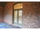 Covered patio features brick walls, tile flooring, and double doors at 120 Chastain Nw Rd # 1104, Kennesaw, GA 30144