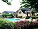 Community pool and patio area with lounge chairs and manicured landscaping at 120 Chastain Nw Rd # 1104, Kennesaw, GA 30144