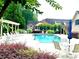 Community pool and patio area with lounge chairs and manicured landscaping at 120 Chastain Nw Rd # 1104, Kennesaw, GA 30144