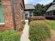 Brick home's side view showcasing lush landscaping, walkway to back, and seamless blend with surroundings at 120 Chastain Nw Rd # 1104, Kennesaw, GA 30144
