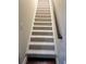 Carpeted staircase featuring white trim and a wooden handrail at 120 Chastain Nw Rd # 1104, Kennesaw, GA 30144