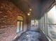 Bright sunroom featuring brick accents, tile flooring, and large windows overlooking the backyard at 120 Chastain Nw Rd # 1104, Kennesaw, GA 30144