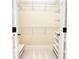 Empty walk-in closet with white shelves and seating area at 120 Chastain Nw Rd # 1104, Kennesaw, GA 30144