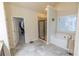Bright bathroom featuring a soaking tub, separate shower, and access to a walk-in closet at 1960 Overlook Springs Ln, Cumming, GA 30040