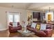 Cozy living room with hardwood floors, comfortable seating, and access to outdoor area at 1960 Overlook Springs Ln, Cumming, GA 30040