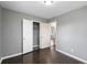 This bedroom has dark hardwood floors, neutral walls, and a closet to store your belongings at 5273 Crystal Ln, Atlanta, GA 30349