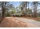 Ranch home with brick facade and long driveway surrounded by mature trees at 5273 Crystal Ln, Atlanta, GA 30349