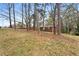 Exterior of a single story brick home with bare lawn surrounded by mature trees at 5273 Crystal Ln, Atlanta, GA 30349