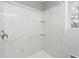 Beautiful tiled shower with shower head and shampoo niche with a window for light at 5273 Crystal Ln, Atlanta, GA 30349
