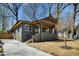Charming exterior of renovated home featuring a covered porch, updated landscaping, and driveway at 936 Byron Sw Dr, Atlanta, GA 30310