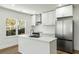 Bright kitchen featuring white cabinets, stainless steel appliances, and an island with a sink at 936 Byron Sw Dr, Atlanta, GA 30310